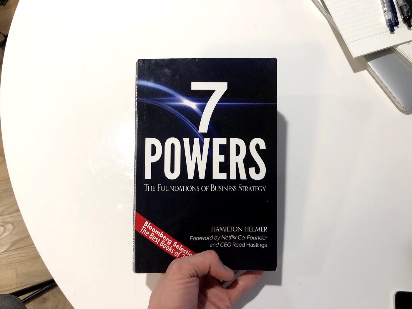 a person holding up a book called 7 powers